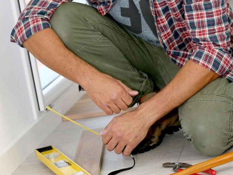 man installing flooring